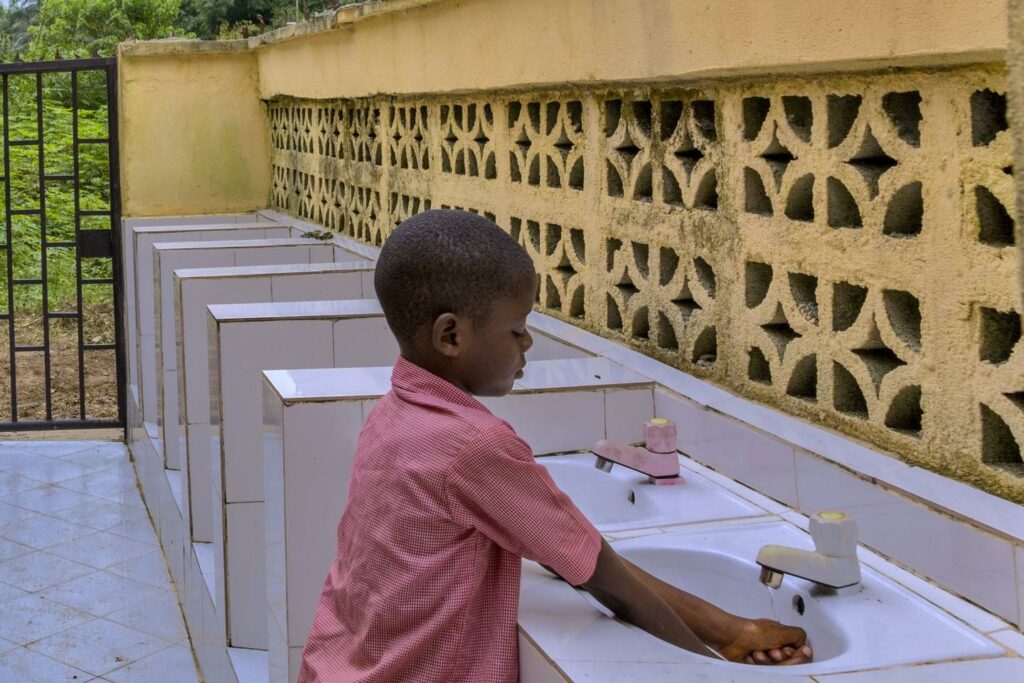 Pupil washing and sanitizing their hands on resumption Day
