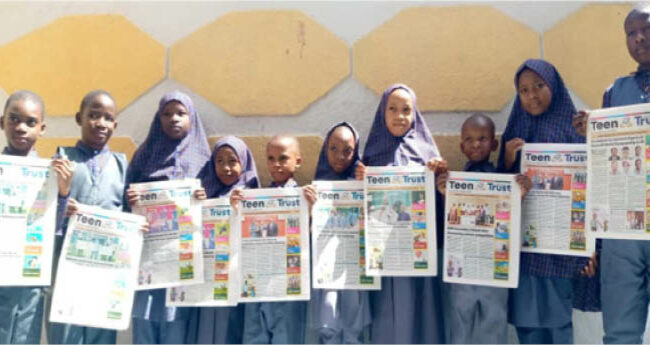 Students of Raudatul-afnan and Islamic model school displaying copies of Teen Trust