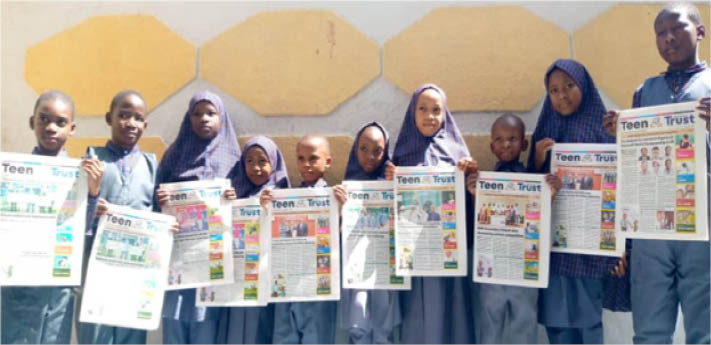 Students of Raudatul-afnan and Islamic model school displaying copies of Teen Trust