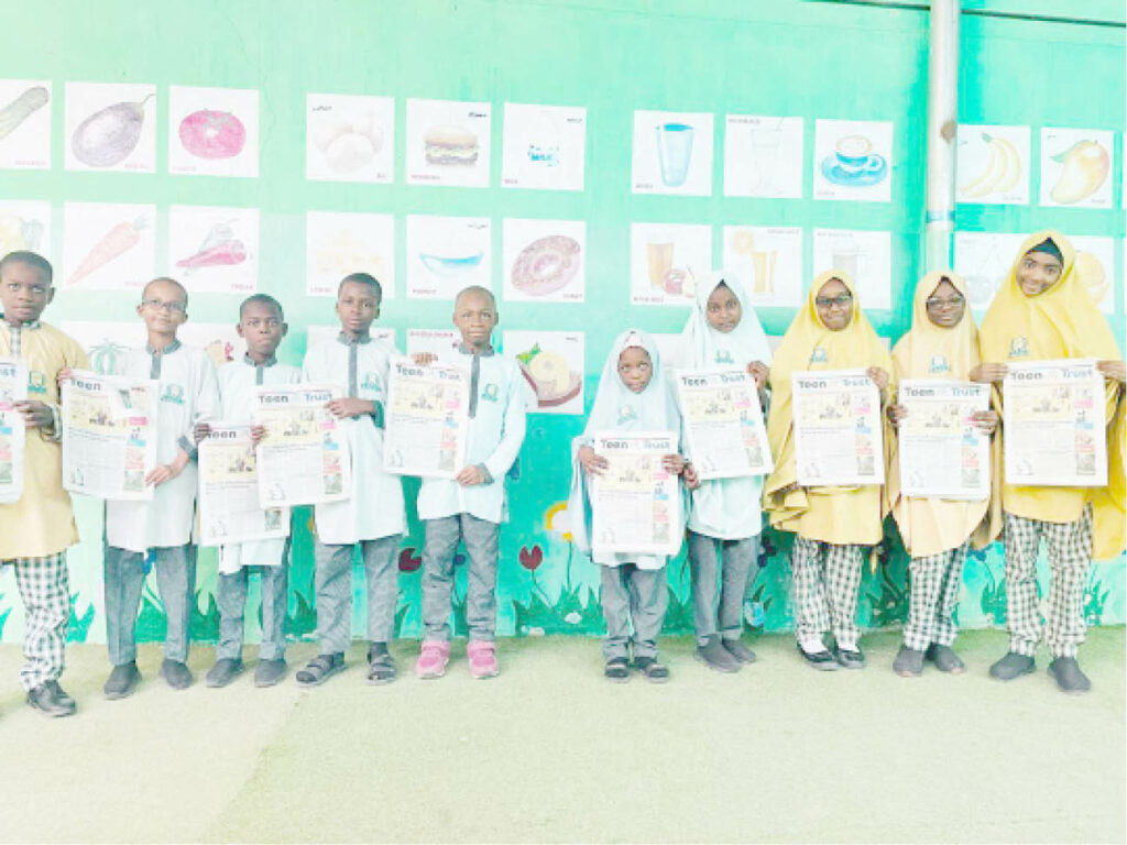Students of Al Bayyinah Basic and Tahfeedh school with copies of Teen Trust newspapers