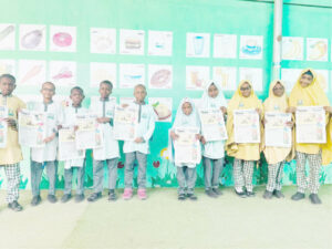 Students of Al Bayyinah Basic and Tahfeedh school with copies of Teen Trust newspapers
