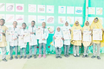 Students of Al Bayyinah Basic and Tahfeedh school with copies of Teen Trust newspapers