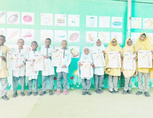 Students of Al Bayyinah Basic and Tahfeedh school with copies of Teen Trust newspapers