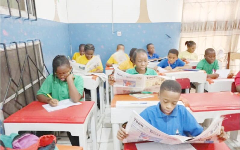 Students of Lordswill Academy, Abuja digesting the content of the Teen Trust Newspaper