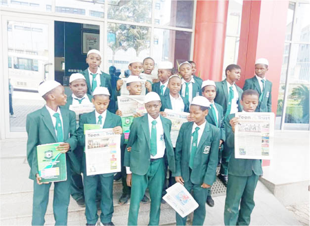 Student of I-Scholars International Academy, Gwarinpa, displaying copies of Teen Trust, during their visit to Media Trust Group Abuja