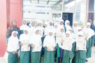 Student of I-Scholars International Academy, Gwarinpa, displaying copies of Teen Trust, during their visit to Media Trust Group Abuja