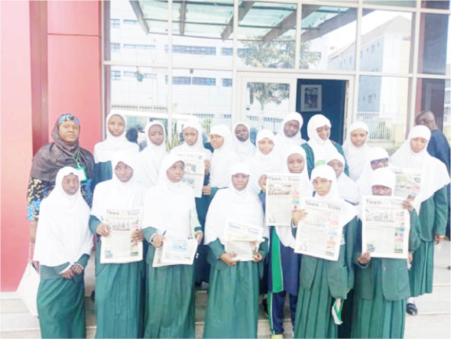 Student of I-Scholars International Academy, Gwarinpa, displaying copies of Teen Trust, during their visit to Media Trust Group Abuja