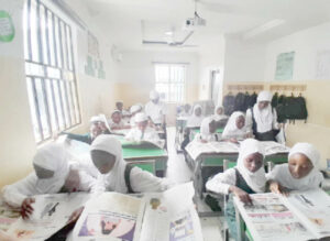 Students of I scholars International Academy reading Teen Trust Newspaper