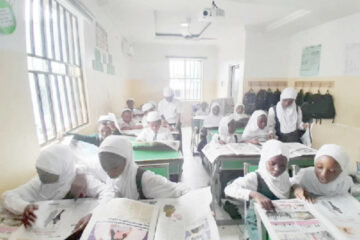 Students of I scholars International Academy reading Teen Trust Newspaper
