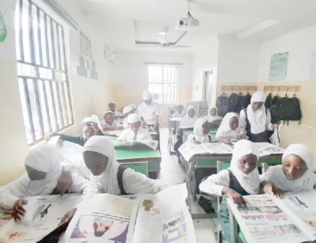 Students of I scholars International Academy reading Teen Trust Newspaper